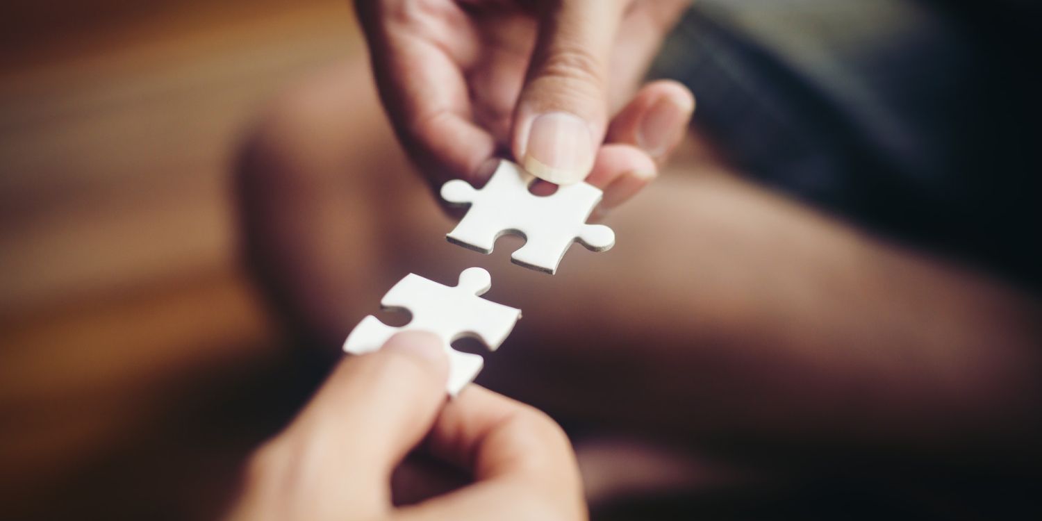 Hand holding jigsaw puzzles, Business partnership concept.