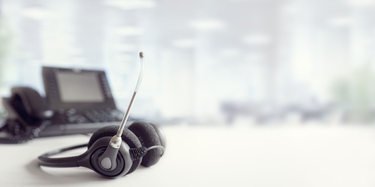 Headset headphones telephone on desk in call centre