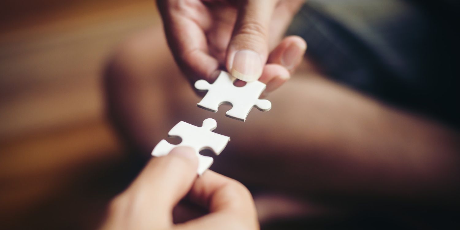 Hand holding jigsaw puzzles, Business partnership concept.